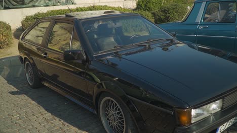 Classic-black-VW-on-display-at-Romania-motor-show,-cobble-parking