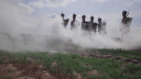 Groups-of-French-Soldiers-attacking-enemy-on-on-a-dry-piece-of-meadow-land,-defying-cannon-smoke