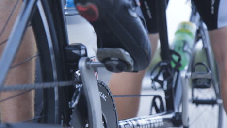 Para-cyclists-clipping-their-shoes-into-the-pedals-of-their-tandem-bicycle-before-riding-off