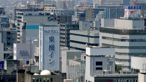 View-of-the-Hotel-area-of-the-city-near-downtown-with-Tokyo-Inn-in-the-middle,-Locked-high-up-shot