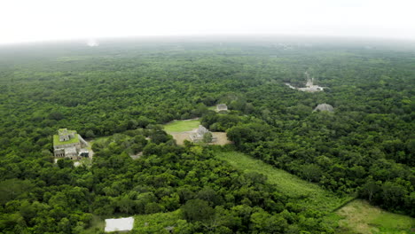 Aerial-perspective-of-the-Chichen-Itza-Pyramid,-court,-observatory,-all-the-buildings-and-jungle-from-above