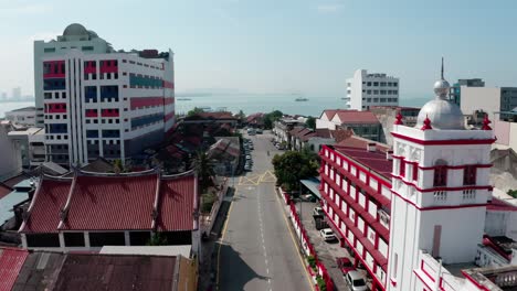 Aerial-view-of-Gat-Lebuh-Chulia-Street-with-Pantai-Fire-and-Rescue-Station-visible-in-the-George-town-area-of-the-island,-Drone-dolly-out-reveal-shot