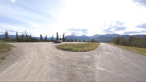 A-black-suv-pulls-into-a-lookout-spot-perfectly-timed-with-a-drone-flying-overhead-to-capture-the-view