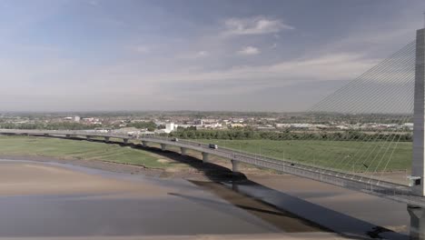 Vehicles-crossing-over-landmark-river-Mersey-gateway-bridge-aerial-view-pan-right-following-traffic