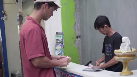 Tanned-male-exchanging-money-for-Indonesian-Rupees-in-Bali