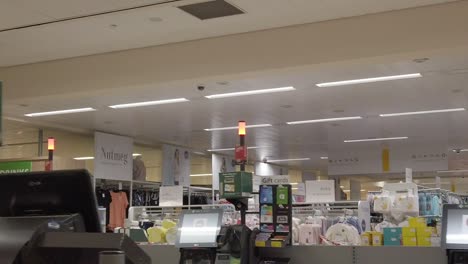 Slow-motion-interior-empty-UK-supermarket-dolly-left-passing-till-section