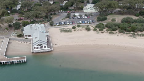 AERIAL-TRUCK-RIGHT-Australian-Coastal-Beach,-Jetty-And-Restaurant