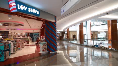 View-Of-A-Toy-Store-With-No-People-Inside-An-Empty-Mall-In-Dubai,-United-Arab-Emirates-During-Coronavirus-Pandemic---panning-shot