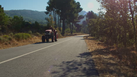 An-old-tractor-passing-by-in-a-nature-setting