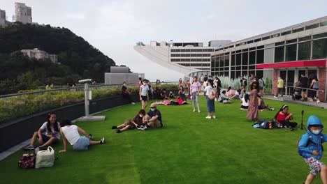 People-enjoying-a-beautiful-day-at-Hong-Kong-Peak-galleria,-on-top-of-Hong-Kong-island-overlooking-Victoria-Harbour