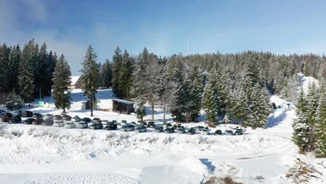 Aerial-view-of-ski-slopes,-Trije-kralji-winter-resort-on-Pohorje,-Slovenia,-few-people-due-covid-restrictions-are-able-to-enjoy-outdoor-activities