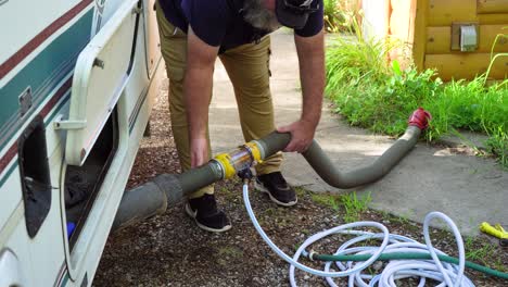 Man-uses-the-washing-feature-on-the-flushing-Grey-Water-disposal-feature