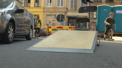 Skater-falls-during-his-landing-after-doing-a-flip-trick-on-a-ramp