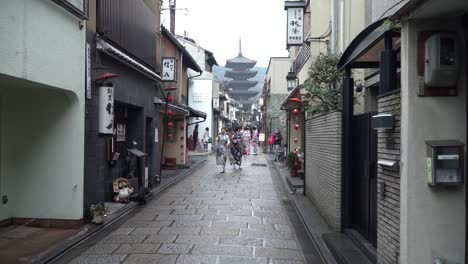 Asian-girls-tourists-walking-around-the-streets-of-Kyoto-in-Japan-wearing-traditional-Japanese-clothes-kimono