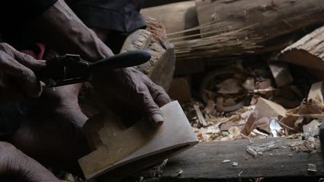 Slow-motion-of-Close-up-on-an-old-Muslim-man-working-wood-in-the-Traditional-Sundanese-village-Kampung-naga