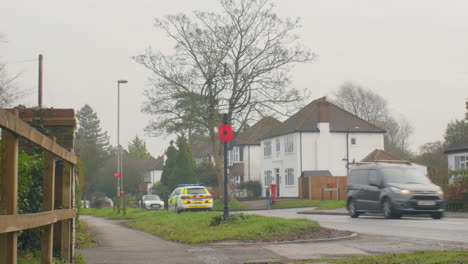 ZOOM-OUT-Middle-class-English-suburb-with-a-police-car-on-patrol-and-a-senior-citizen-with-a-shopping-bag