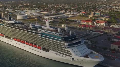 Aerial-view-of-the-bow-on-big-cruise-ship-in-dock-with-a-tilt-and-pan-up-into-the-skies