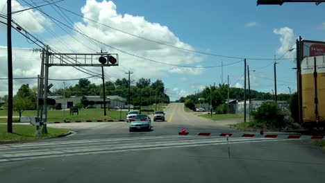 end-of-a-train,-train-crossing-and-gate-rising-for-cars