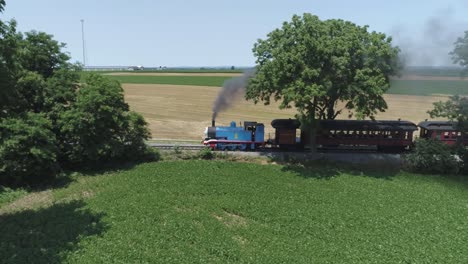 Aerial-View-of-a-Thomas-the-Tank-Engine-with-Passenger-Cars-Puffing-along-Amish-Countryside