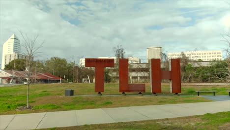 Aerial-View-of-TLH-Statue-With-Buildings-in-Background-in-Tallahassee,-Florida-USA