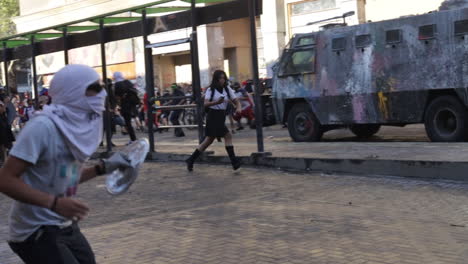 Riot-police-vehicle-drives-forward-to-scatter-rioters-in-downtown-Santiago