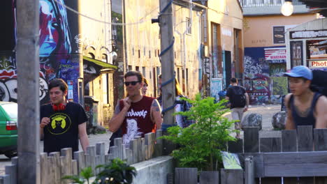 A-group-of-people-walking-through-Raw-Gelände,-Berlin,-Germany