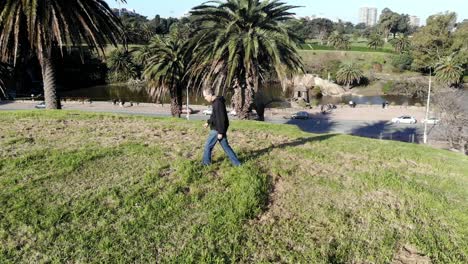 Aerial-footage-adult-man-walking-in-the-park