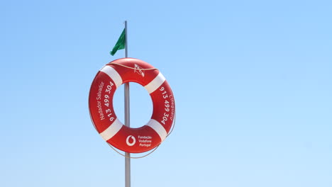 Close-up-of-lifebuoy-hanging-against-blue-sky