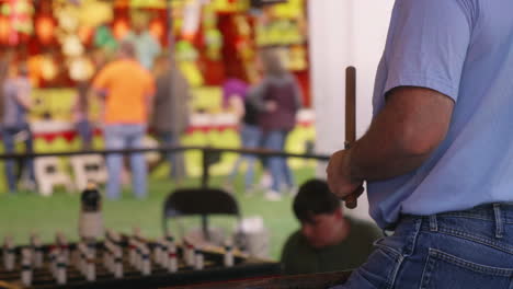 Man-playing-ring-toss-game,-Medium-Shot,-Over-the-Shoulder