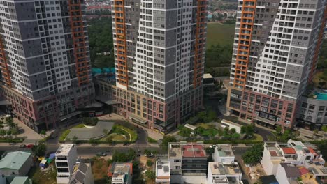 Aerial-tilt-shot-from-top-to-bottom-a-row-of-identical-modern-residential-buildings-on-a-sunny-day-with-blue-sky