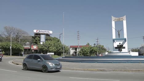 Una-Toma-Panorámica-De-Izquierda-A-Derecha-Del-Tráfico-Pasa-Por-La-Rotonda-Frente-Al-Monumento-A-La-Constitución-Durante-Un-Día-Soleado