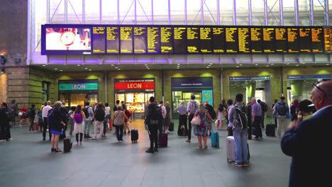 London-England,-circa-:-crowded-people-at-Arrivals-departure-board,-Airport---Train-station-in-King-Cross,-London,-England,-UK