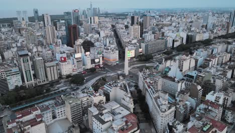 Aerial-orbital-of-Obelisk-monument-in-9-de-Julio-and-Corrientes-avenue-intersection,-downtown-Buenos-Aires