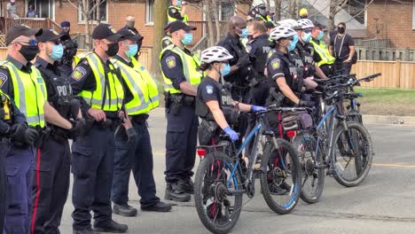 Line-of-Police-with-bike-blocking-access-on-the-street