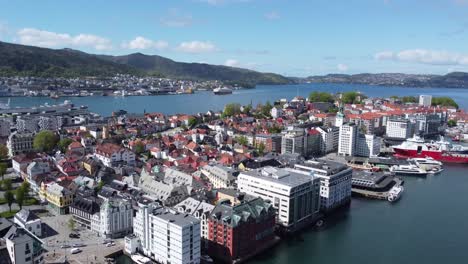 Nordnes-Bergen-and-Hurtigruten-cruise-ship-arriving-in-Background---Aerial