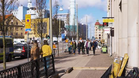 People-Walking-On-Sidewalk-At-Busy-Street-Near-Jarntorget-In-Gothenburg,-Sweden