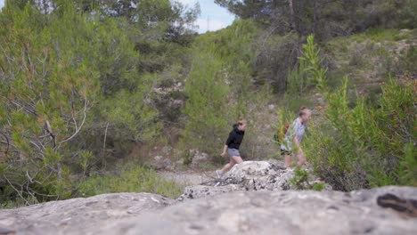 Two-young-women-hiking-in-an-evergreen-mountain-forest,Valencia,Spain