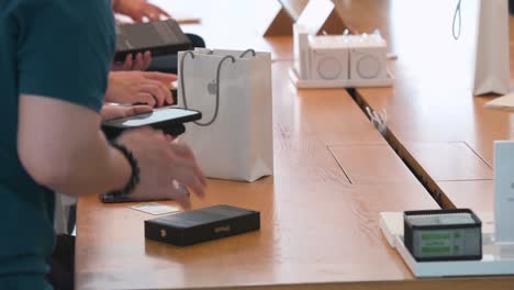 Customers-are-seen-purchasing-Apple-brand-products-at-an-Apple-store-during-the-launch-day-of-the-new-iPhone-13-series-smartphones-in-Hong-Kong