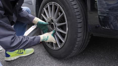 Ein-Mann-Macht-Es-Selbst,-Wechselt-Die-Reifen-An-Seinem-Auto-Und-Zieht-Sie-Mit-Einem-Kreuzschlüssel-Fest