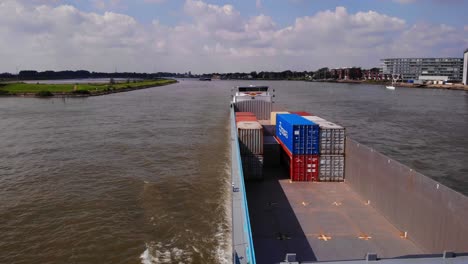 Aerial-Static-View-Of-Acadia-Cargo-Ship-Going-Past-On-River-Noord