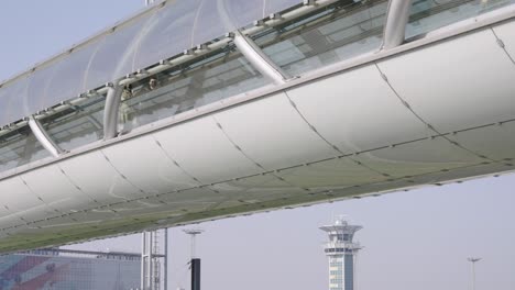 Couple-of-people-walking-in-Paris-Orly-airport-pedestrian-bridge-tunnel