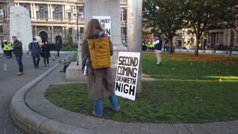 A-woman-reads-religious-banners-about-the-end-of-the-world