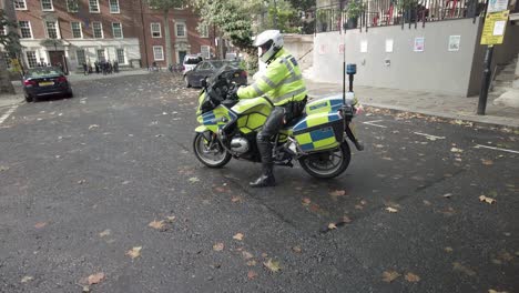 Oficiales-De-Policía-En-La-Bicicleta-Con-Luces-Intermitentes-Durante-El-Día-Tráfico-Multitud-Protestas