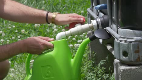 filling-watering-can-with-rain-catcher-man-with-gold-watch-outside