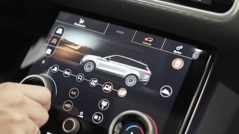 man's-hand-touching-car-terrain-response-driving-modes,-land-rover-velar