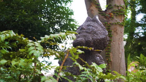 Japanese-statue-of-mythical-creature-sits-amongst-nature-in-a-peaceful-green-Tokyo-park