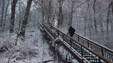 Plano-General-De-Un-Corredor-Subiendo-Una-Escalera-Cubierta-De-Nieve-En-Un-Bosque