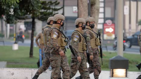 slow-motion-of-army-soldiers-walking-in-the-street,-El-Salvador