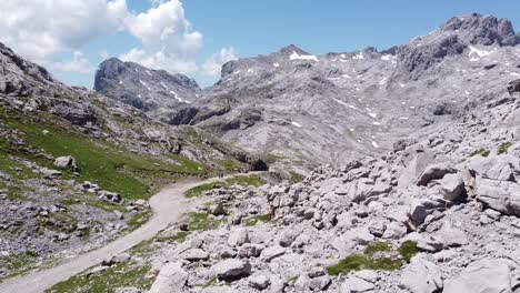 National-Park-Picos-de-Europa,-Asturias-and-Cantabria,-Spain---Aerial-Drone-View-of-the-Hiking-Trail-at-the-Peak-of-the-High-Mountains-with-Snow