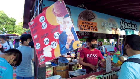 Local-ice-cream-store-at-the-downtown-city-square-with-tourist-wearing-masks-during-the-pandemic